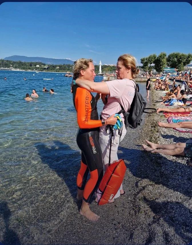 Arrivée sur la plage de Genève, accueillie après la traversée, phare des Pâquis au loin